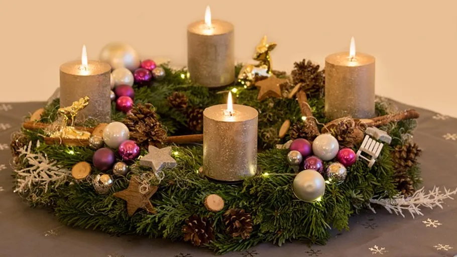 Advent wreath with candles on table.