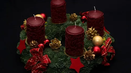 Four red candles on a decorated wreath.