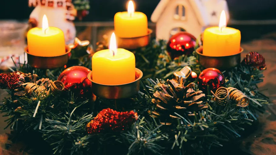 Adventskranz mit vier brennenden Kerzen, Dekorationen.