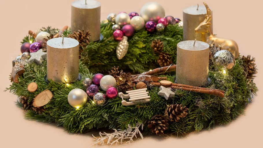 Holiday wreath with candles and decorations.