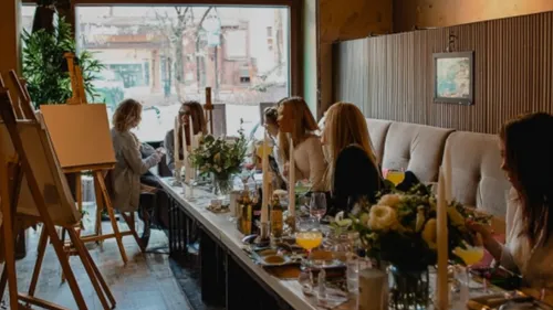 People painting and dining in cozy interior setting.