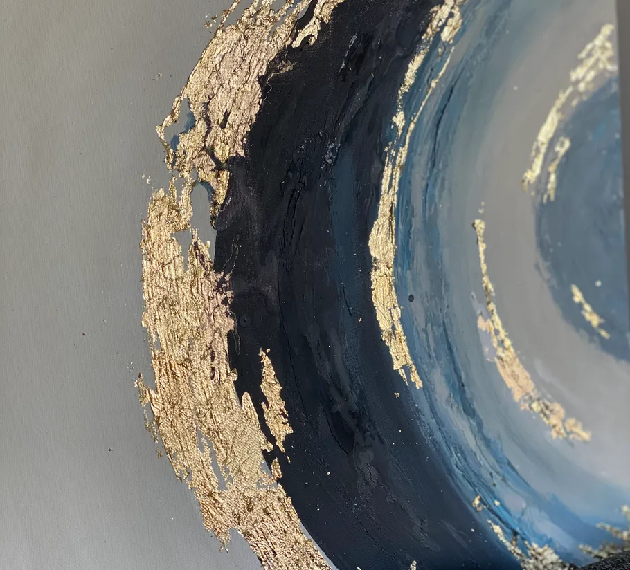 Abstract painting with gold and blue swirls.