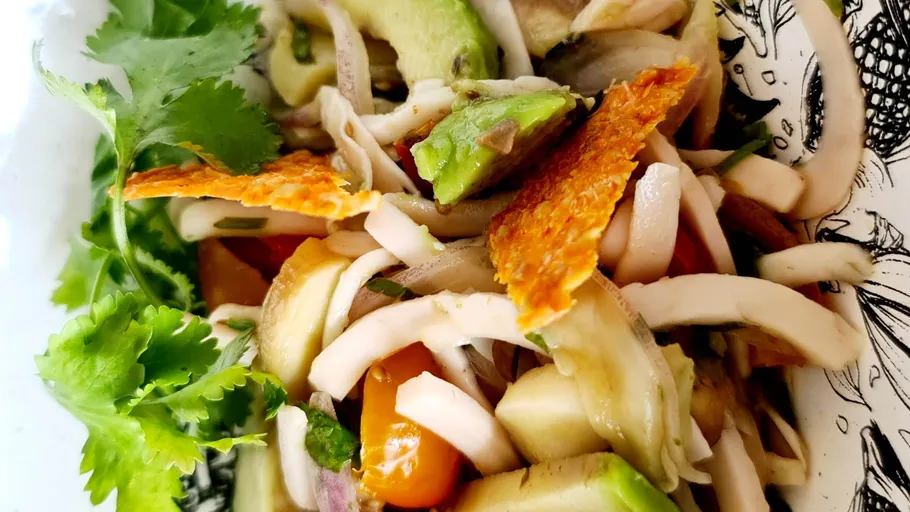 Salad with avocado and cilantro in bowl.