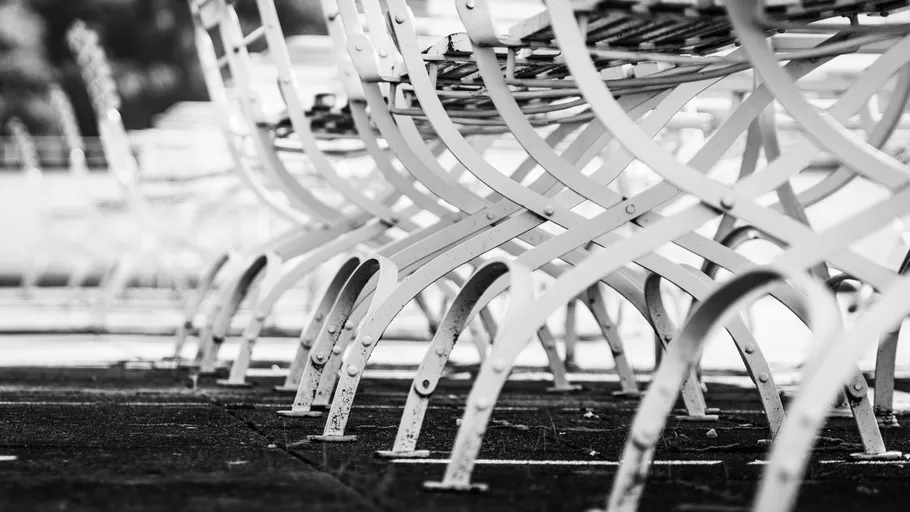 Metal chair legs arranged in rows outside.
