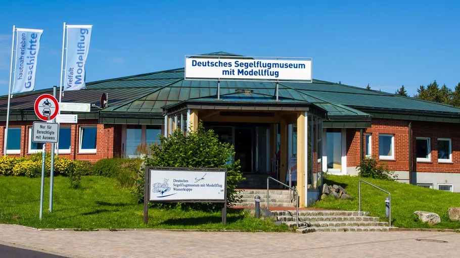 Museum building with entrance and signs.