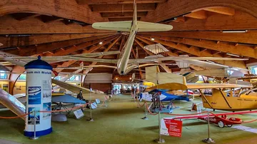 Gliders displayed in aviation museum hall.