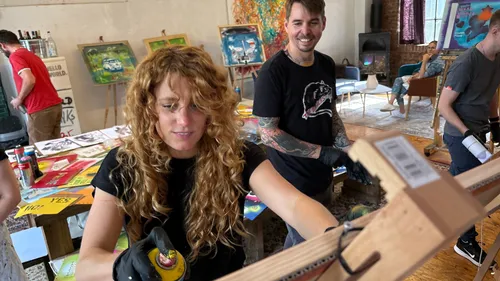 People creating art in a studio setting.