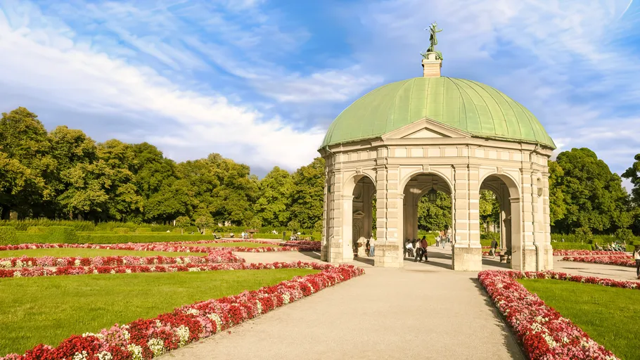 Pavilion with green dome in a garden.