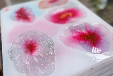 Colorful rounded resin shapes on white surface.