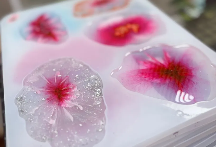 Colorful rounded resin shapes on white surface.