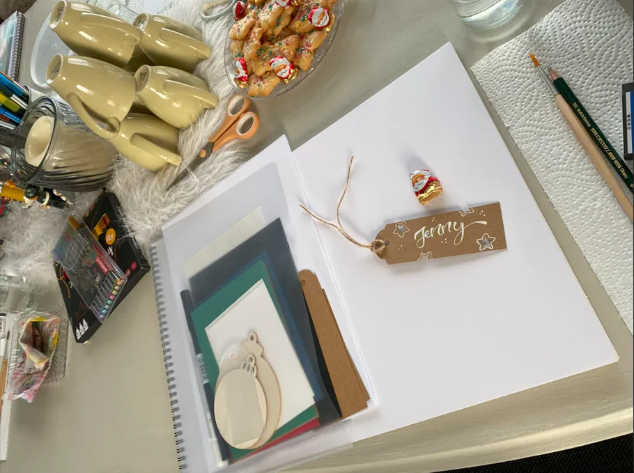 Craft table with supplies and cookies.