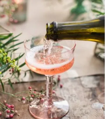 Rose champagne poured into elegant glass.