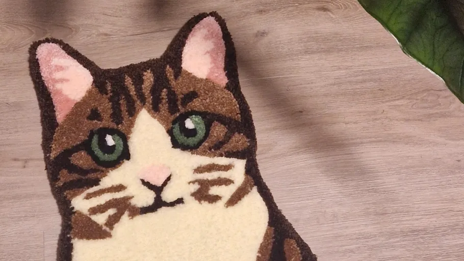 Cat-shaped rug on wooden floor.