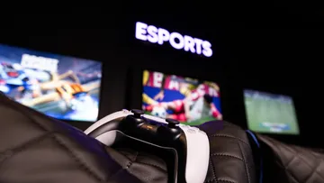 Game controller on chair in esports setting.