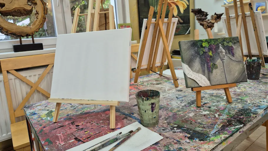 Art studio with blank canvases and painted easel.
