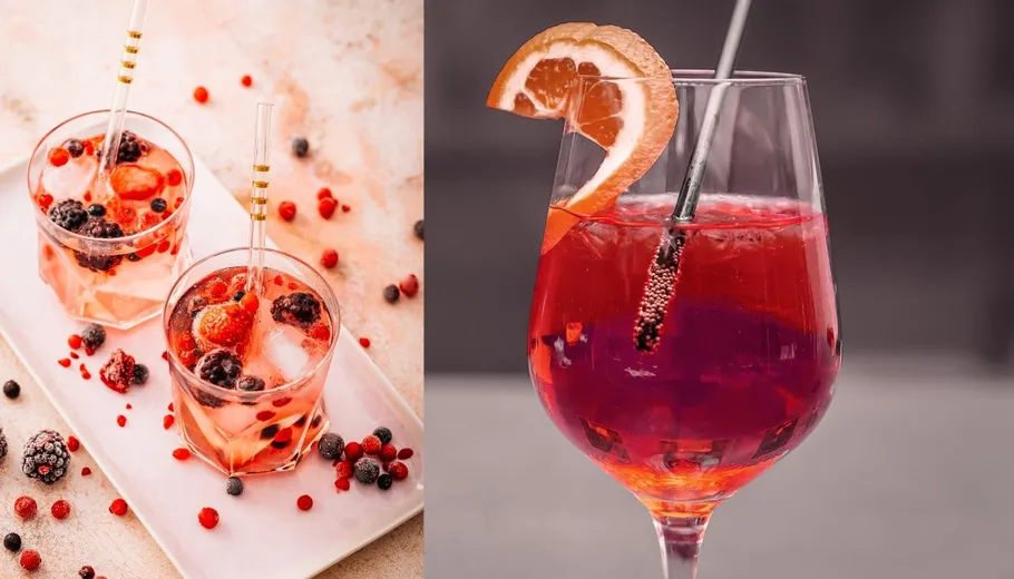 Two drinks with berries and an orange slice.