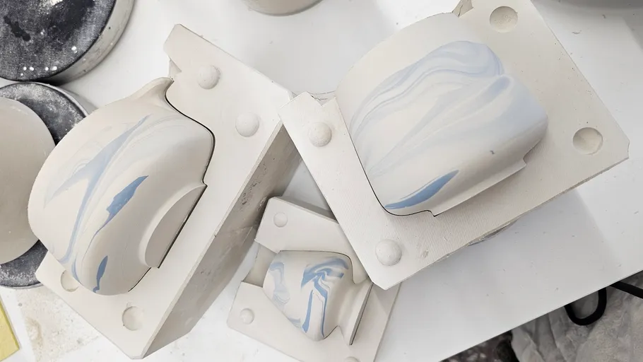 Ceramic molds with blue marbled design.