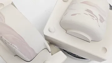 Two ceramic molds with marbled designs.