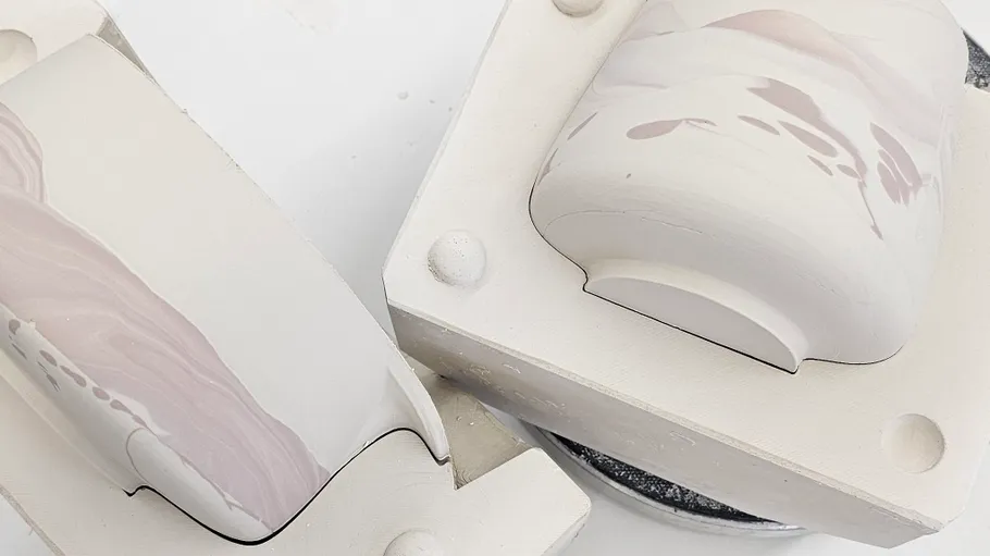 Two ceramic molds with marbled designs.