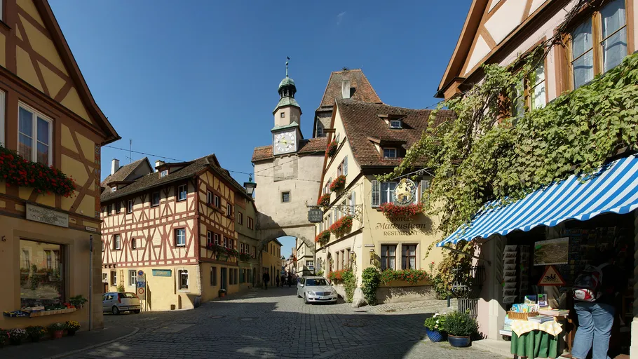 Historic town street with colorful half-timbered buildings.