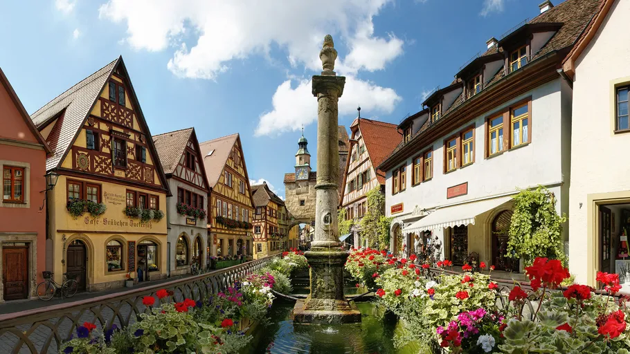 Colorful street with historic buildings and flowers.