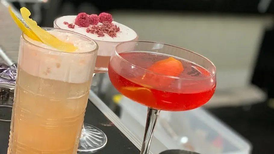 Three cocktails on a bar counter.