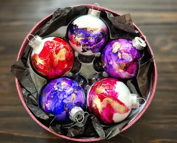 Colorful Christmas ornaments in round box.