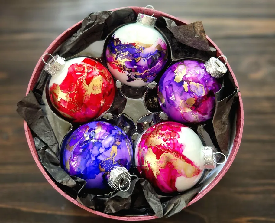Colorful Christmas ornaments in round box.