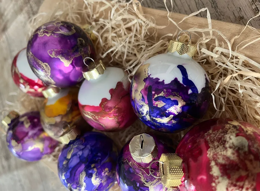 Colorful Christmas ornaments on wooden surface.
