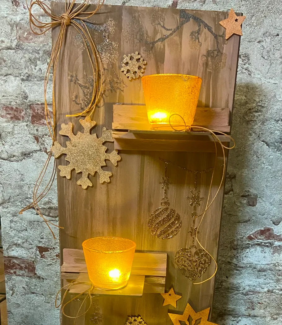 Wooden decor with candles and ornaments on brick wall.