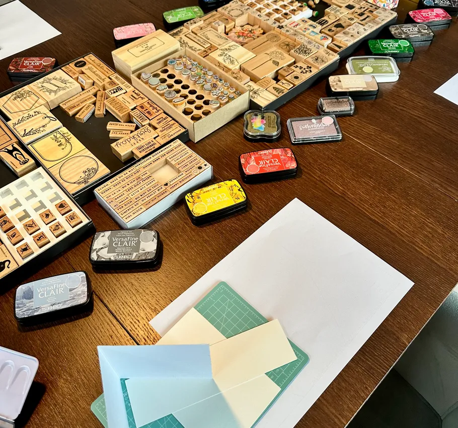 Stamping supplies arranged on a wooden table.