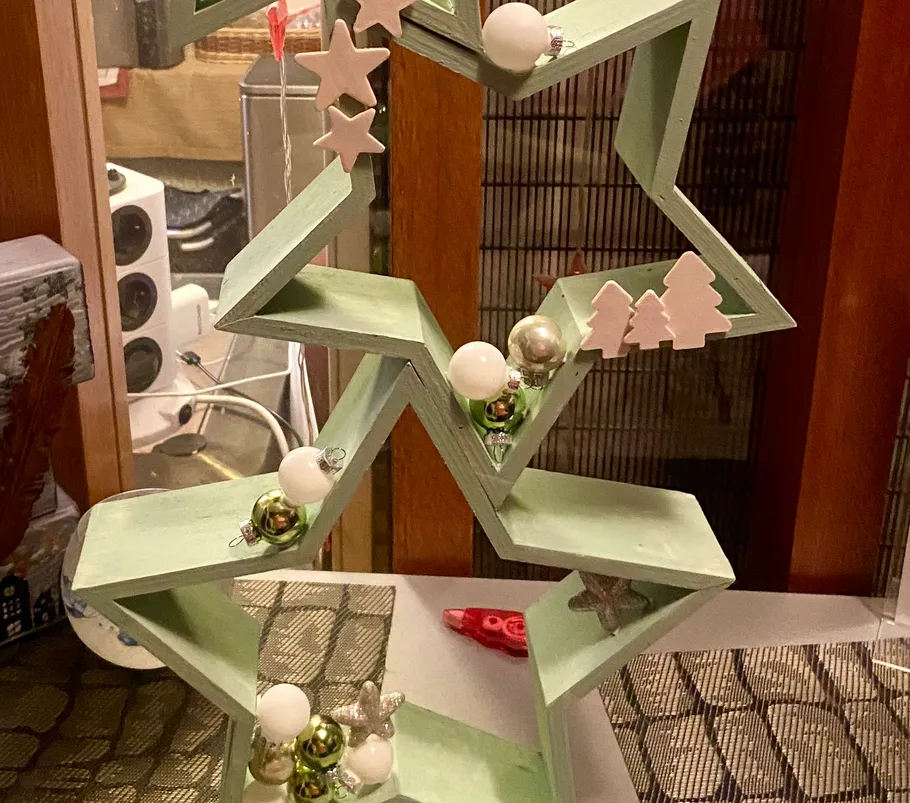 Wooden Christmas decoration with shelves and ornaments.