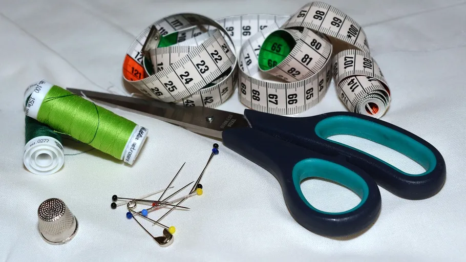 Sewing tools on a white surface.