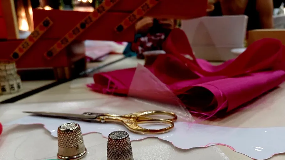 Sewing tools and fabric on a table.