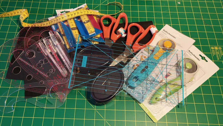 Craft tools scattered on a green cutting mat.