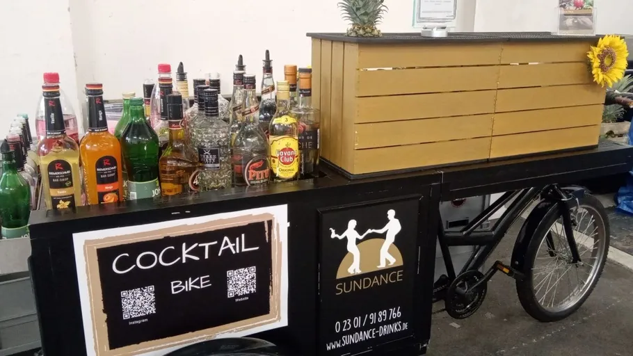 Bicycle with cocktails in urban setting.