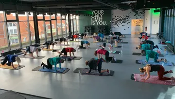 People exercising in a fitness class, indoor studio.