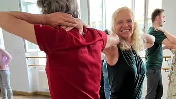 Two people dancing in a studio.