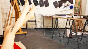 Person's legs up in an art studio.