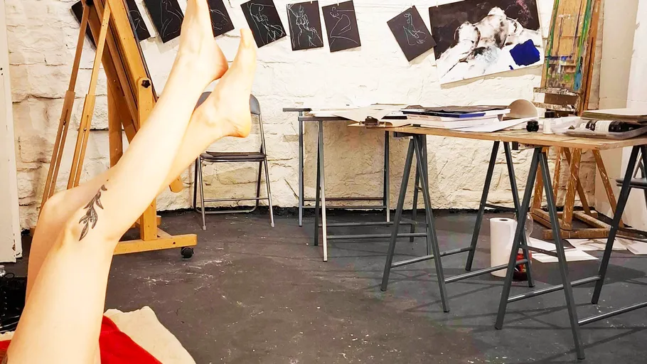 Person's legs up in an art studio.