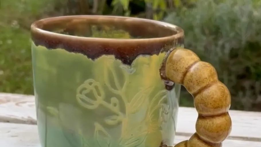 Keramikbecher mit strukturiertem Griff im Freien.