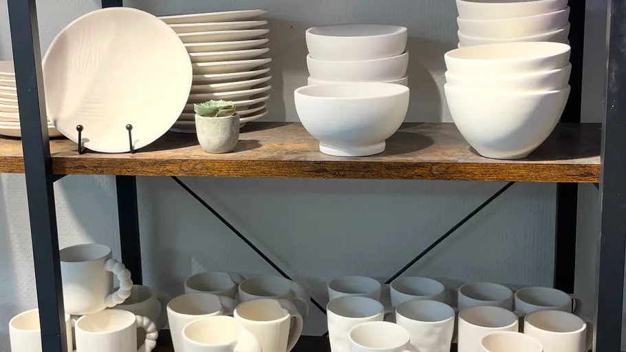 White ceramic dishes on wooden shelves.