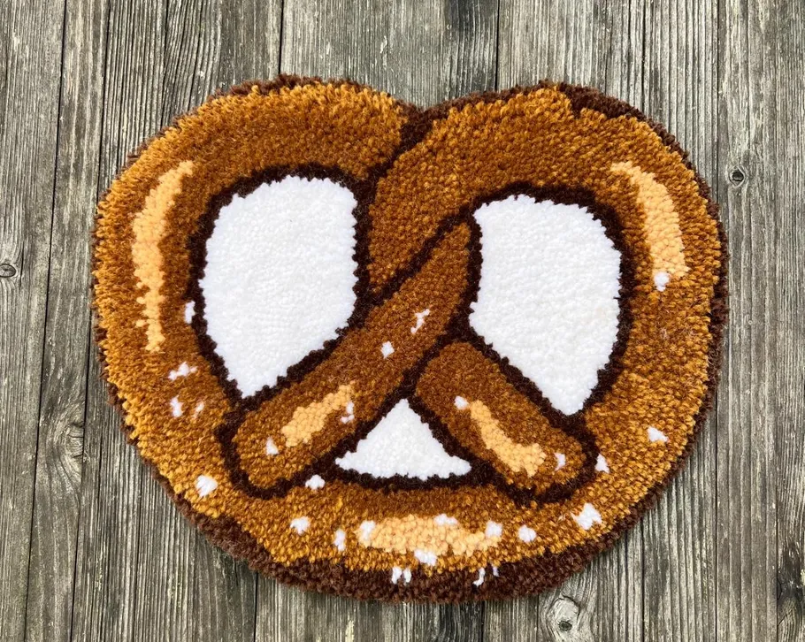 Rug shaped like a pretzel on wood floor.