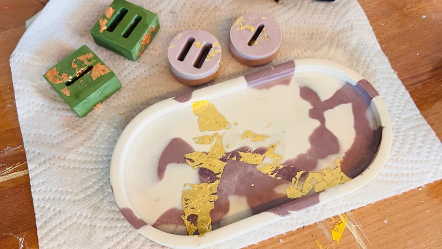 Decorative tray and soap holders with gold leaf accents.