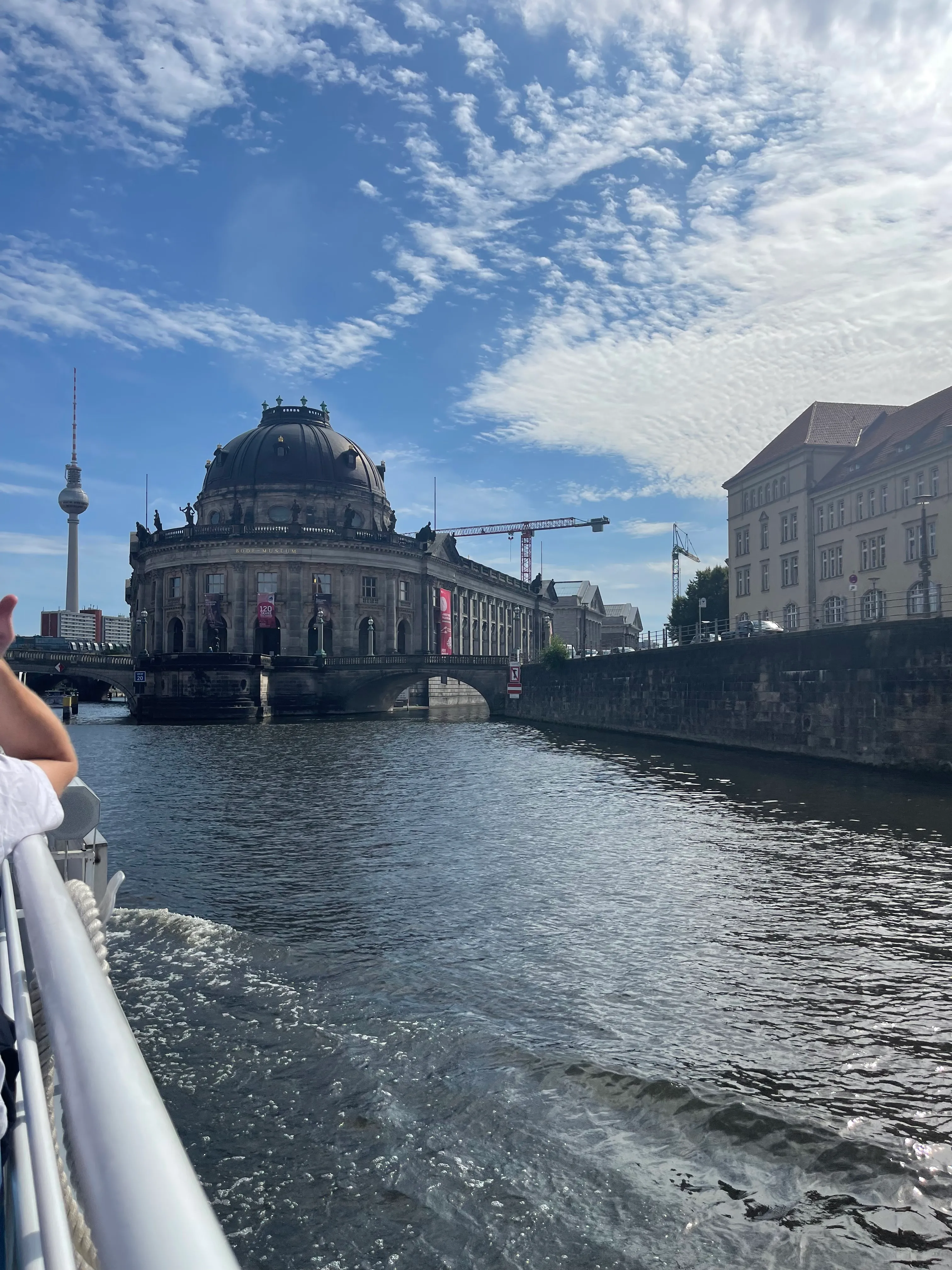 Boat on river near historic dome building.