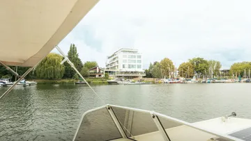 View from boat, hotel by riverside.