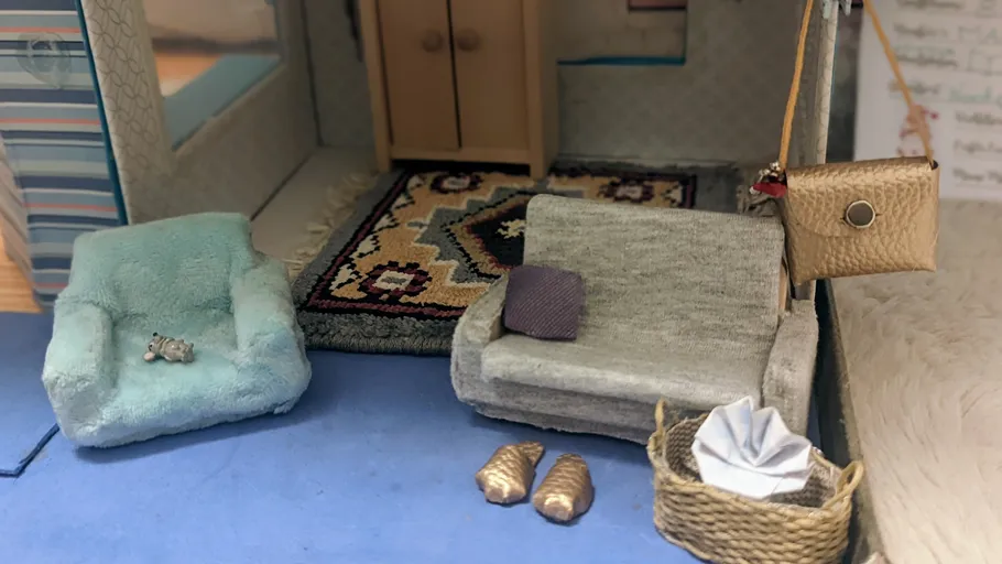 Miniature furniture set in cozy dollhouse room.