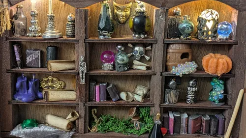 Miniature witch's shelf with various mystical items.