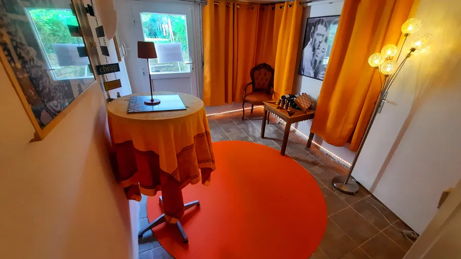 Room with orange decor and vintage chair.