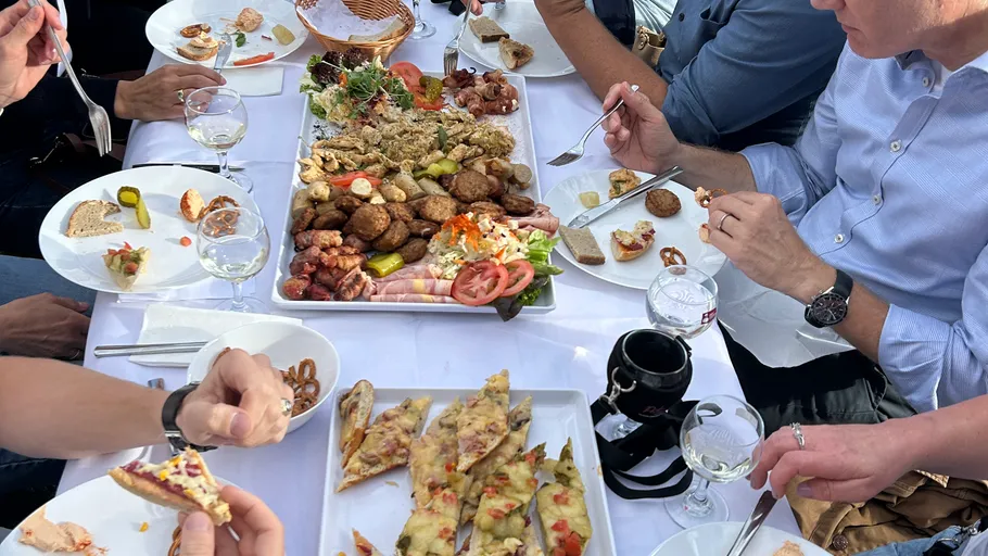 People dining, sharing assorted dishes on table.